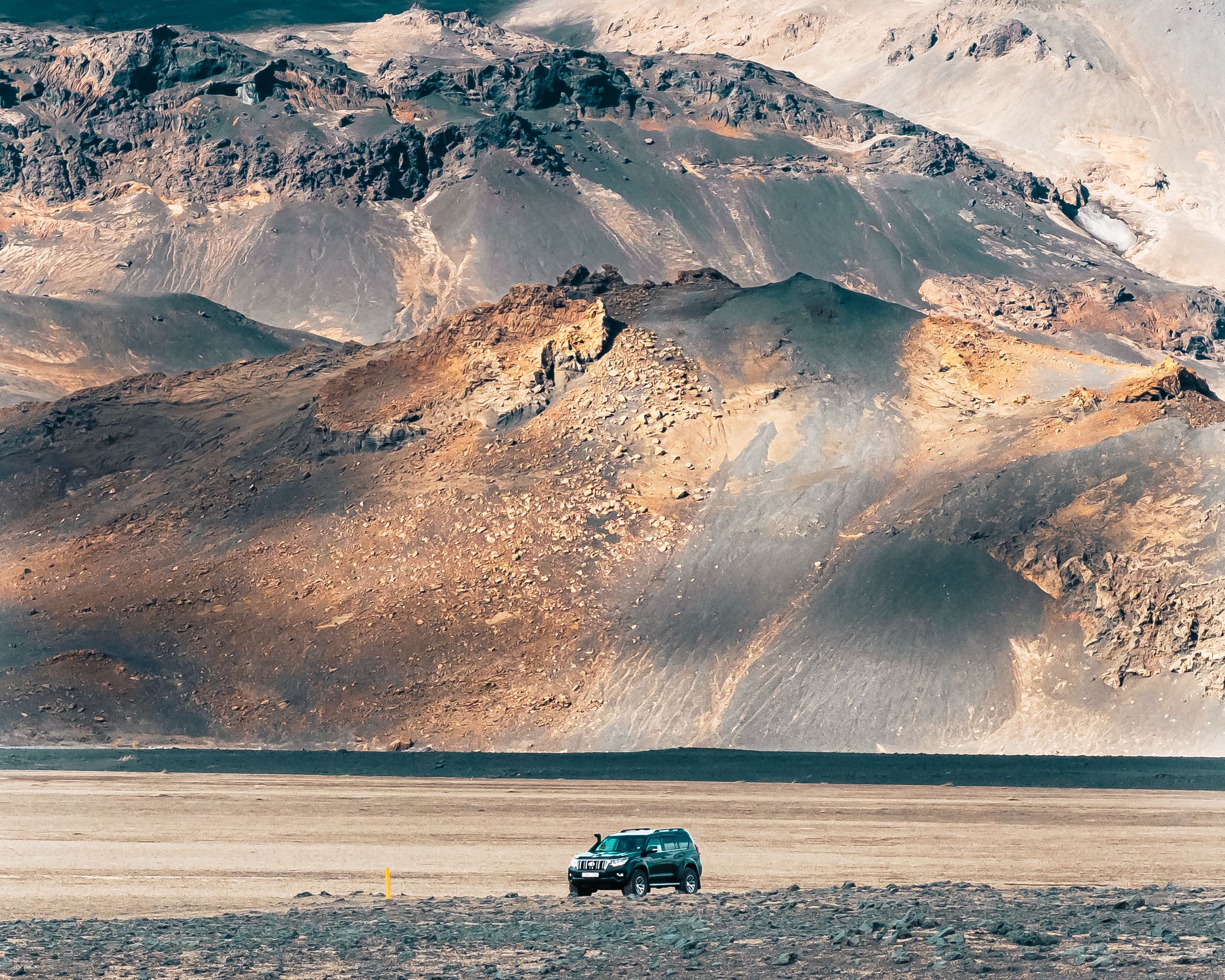 Modified Toyota Land Cruiser 150 with 35 inch tires driving through volcanic sand near Askja, Iceland.